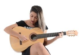 attractive woman playing guitar