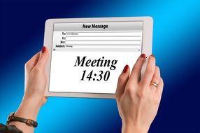 schedule meetings on tablet in female hands