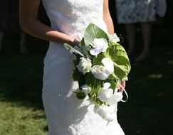 white bouquet in the hands of the bride