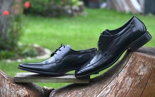 black shoes stand on a stump