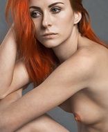 photo of a naked girl with bright red hair