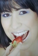 portrait of a model eating strawberry