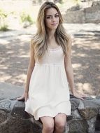 pretty young model sitting on rocks