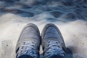 Old sneakers on a sand