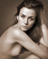 nude girl sitting on the bed