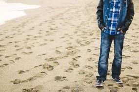 young man in jeans clothes on the beach