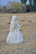 Girl in a white dress in a field