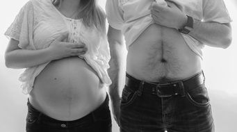 the abdomen of a pregnant woman and dad of the child