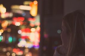 lonely woman at the window of a night city