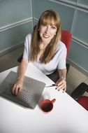 happy girl sitting at office desk