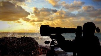 photographer taking picture of sunset