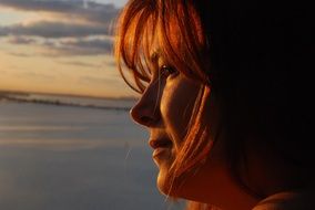 the girl's face in the setting sun
