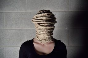 girl's head covered with rope