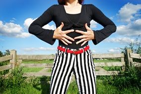in striped pants with a red belt