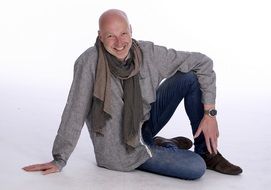 elegant man in a long scarf and jeans