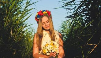 girl in flower wreath and bouquet