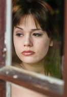 sad woman near the window