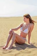 girl in a white bikini on the beach