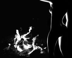 Black and white photo of the woman near the campfire