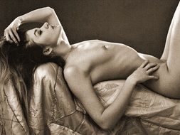 black and white photo of a naked girl on the couch