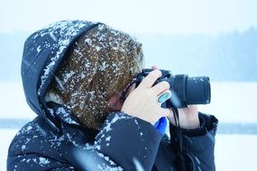 Woman is taking photos in winter