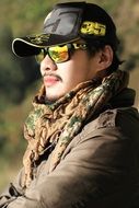 man in sunglasses and cap in thailand