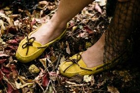 girl legs in yellow moccasins
