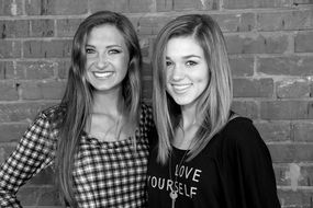 black and white photo of two young models