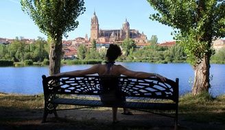 woman on a bench in a picturesque park