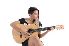 woman with stylish haircut playing guitar