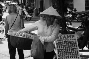 asian woman with full basket, Street Trading, Vietnam, Saigon