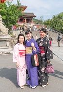 Japanese women in kimono stand on the street