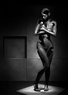 black and white photo of a sculpture of a naked girl