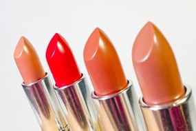 brown and red lipstick on white background
