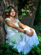 photo of beautiful young woman in the charming forest