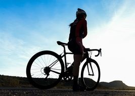 silhouette of a woman on bicycles