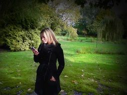 girl with Iphone in the park