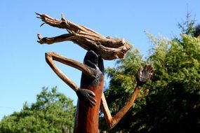 wooden running sculpture among the trees