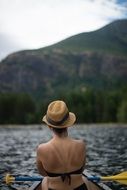 girl in a wicker hat in a boat