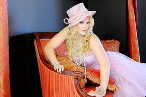 glamorous model in a pink dress and hat
