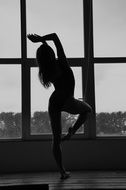 silhouette of the gymnast on the background of the window