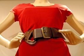red dress with a leather belt on a mannequin close-up