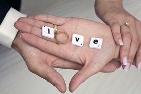 word "love" in the hands of the newlyweds