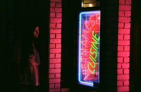 woman near the neon sign