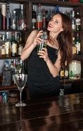 girl with a bottle in hand at the bar