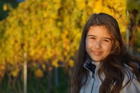 little girl on a background of autumn trees