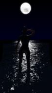 Full Moon light over the lake and woman on the shore