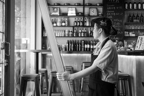 black and white photo of the worker in a restaurant