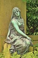 bronze sculpture of a woman on the grave