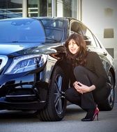business lady near black mercedes